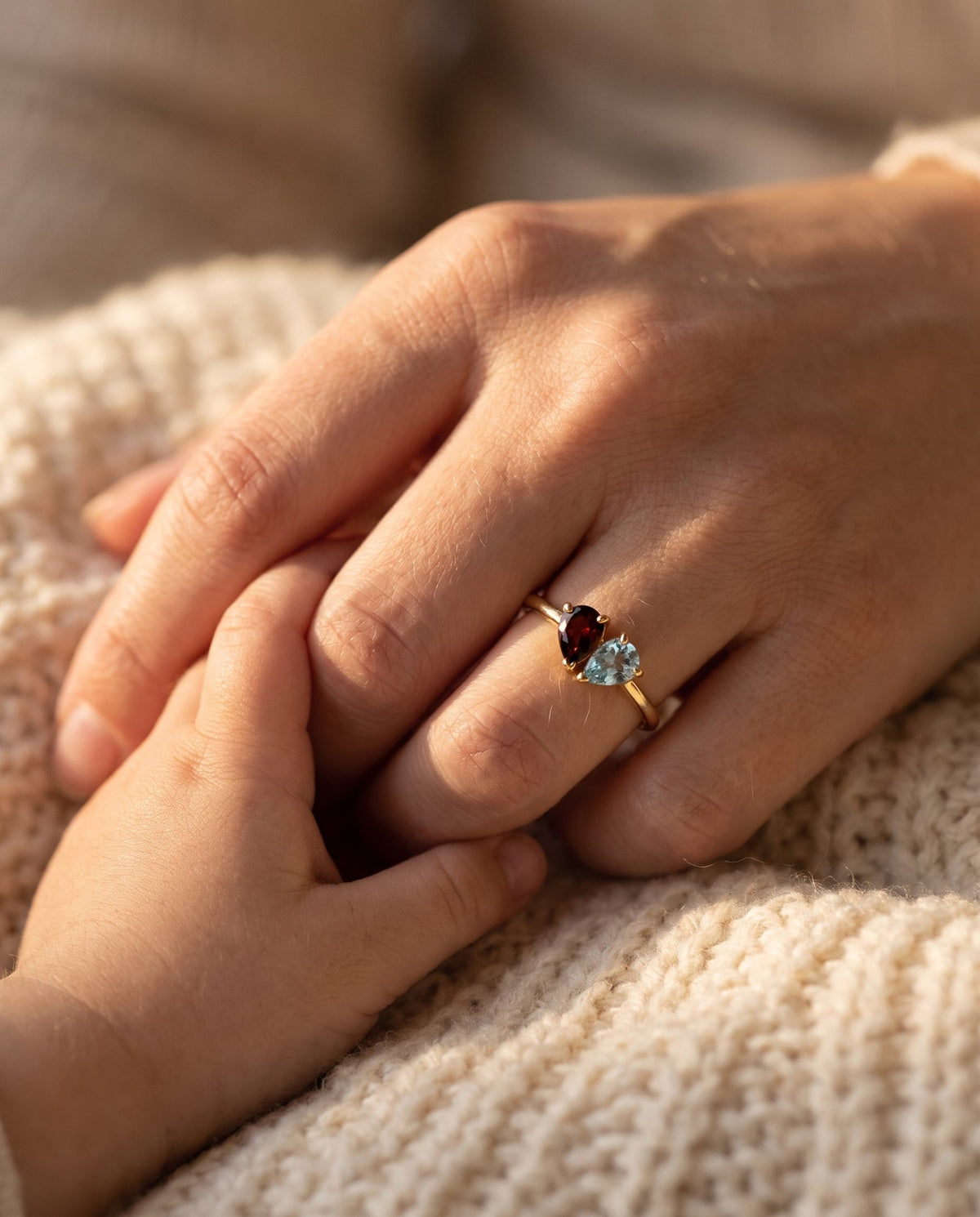 Mother wearing the Duo Birthstone Ring, holding her child's hand